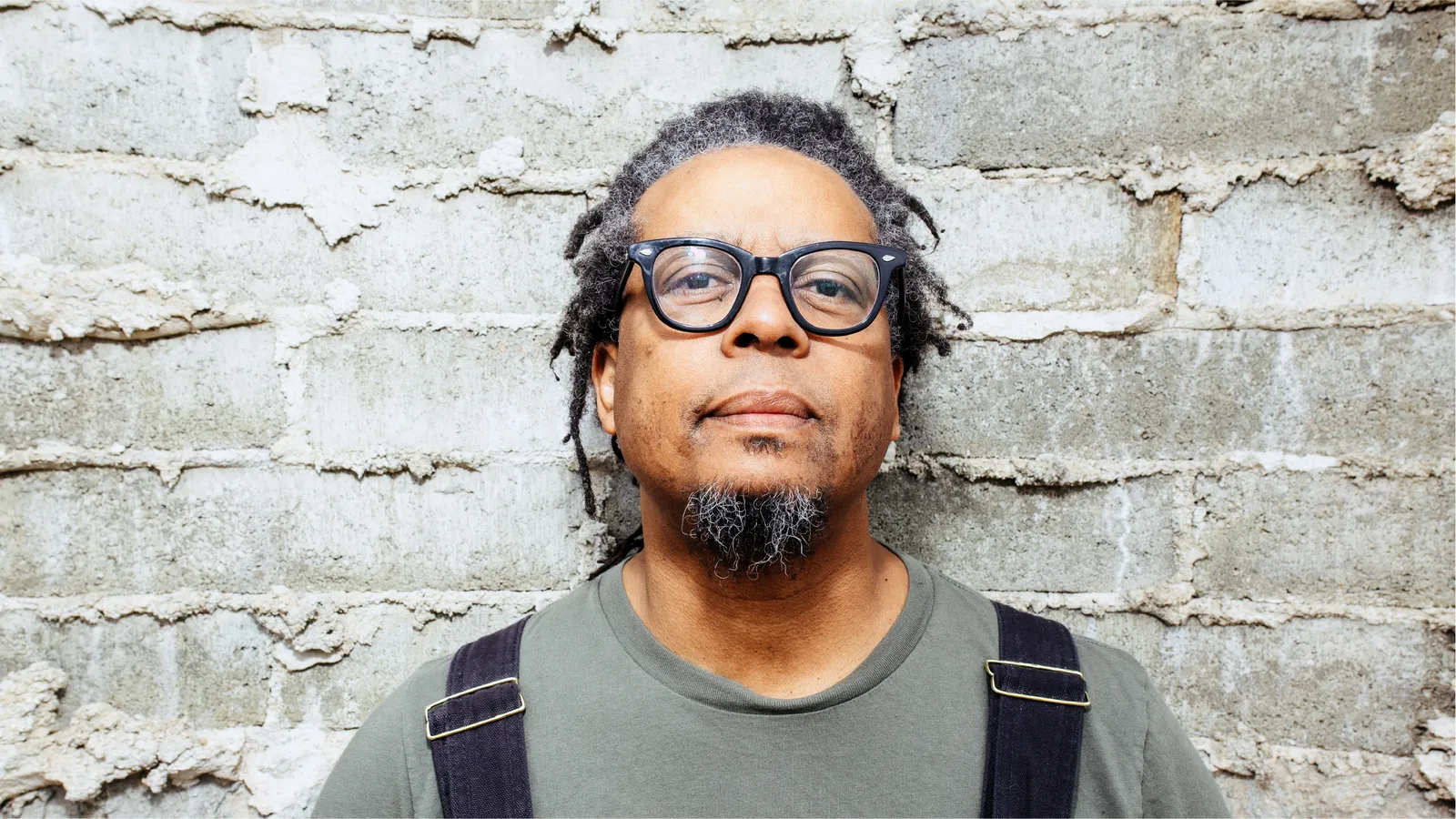 Jeff Parker looking serious in front of a brick wall